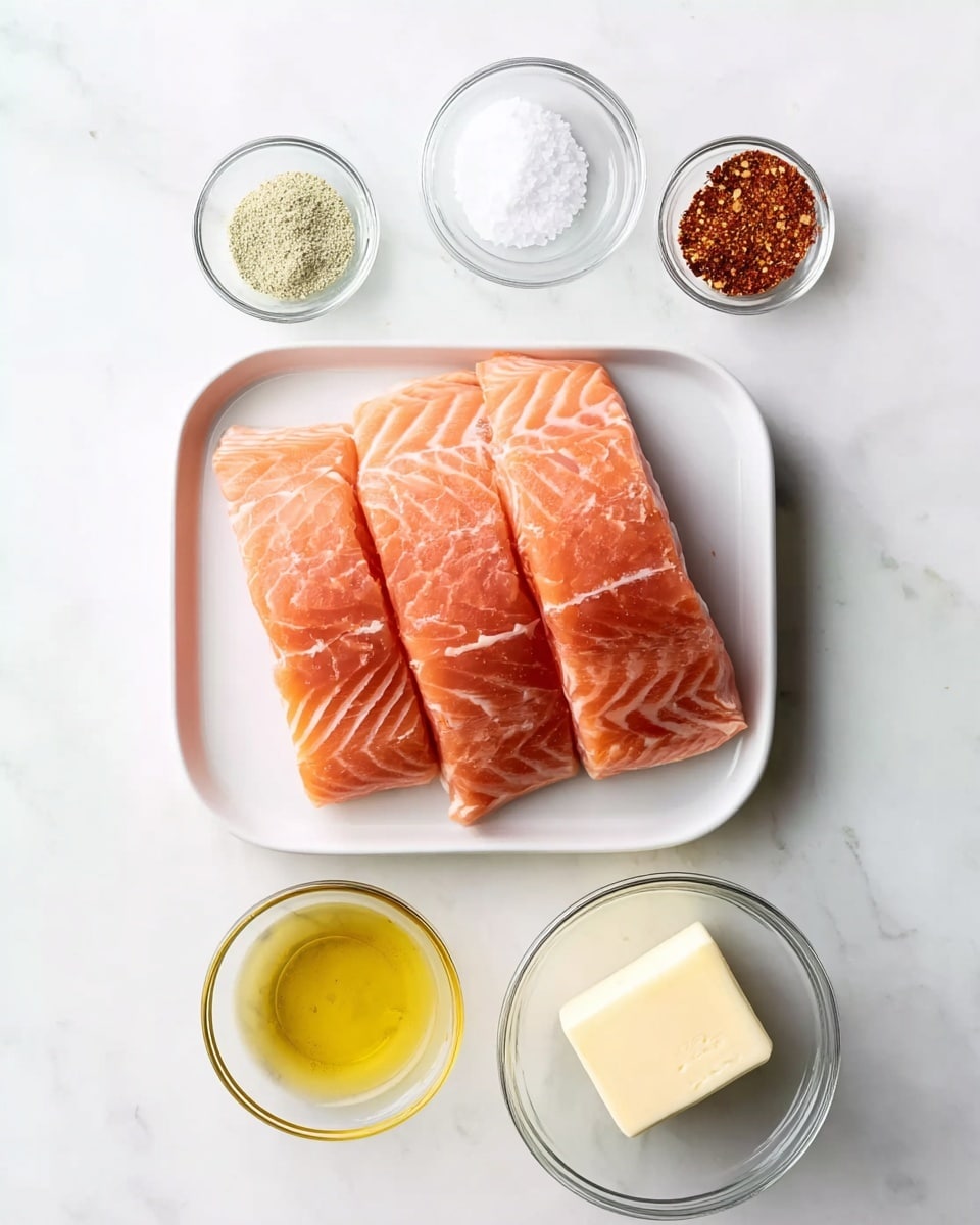 The image shows a white tray with three pieces of fresh pink-orange salmon fillets with visible white lines of fat, placed in the center of a white marbled surface. Surrounding the tray are five small clear glass bowls arranged loosely in a circle: at the top right a bowl with a reddish-brown spice mix, top left a bowl with a pale green powder, middle left a bowl with white granulated salt, bottom left a bowl with golden-yellow oil, and bottom center a bowl with a pale yellow cube of butter. The setup is simple with a clean and bright look, and the colors contrast well against the white marbled background. photo taken with an iphone --ar 4:5 --v 7
