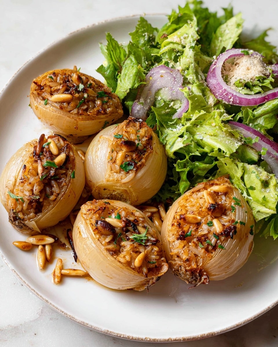 A white plate with four stuffed onions arranged closely on the left side. Each onion is golden brown and split open to show a filling of rice mixed with herbs and pine nuts, some pine nuts scattered on top and around the onions. To the right of the onions is a fresh green salad with mixed leafy lettuce, thin slices of red onion, and a light sprinkle of grated cheese or seasoning. The plate rests on a white marbled surface. Photo taken with an iphone --ar 4:5 --v 7