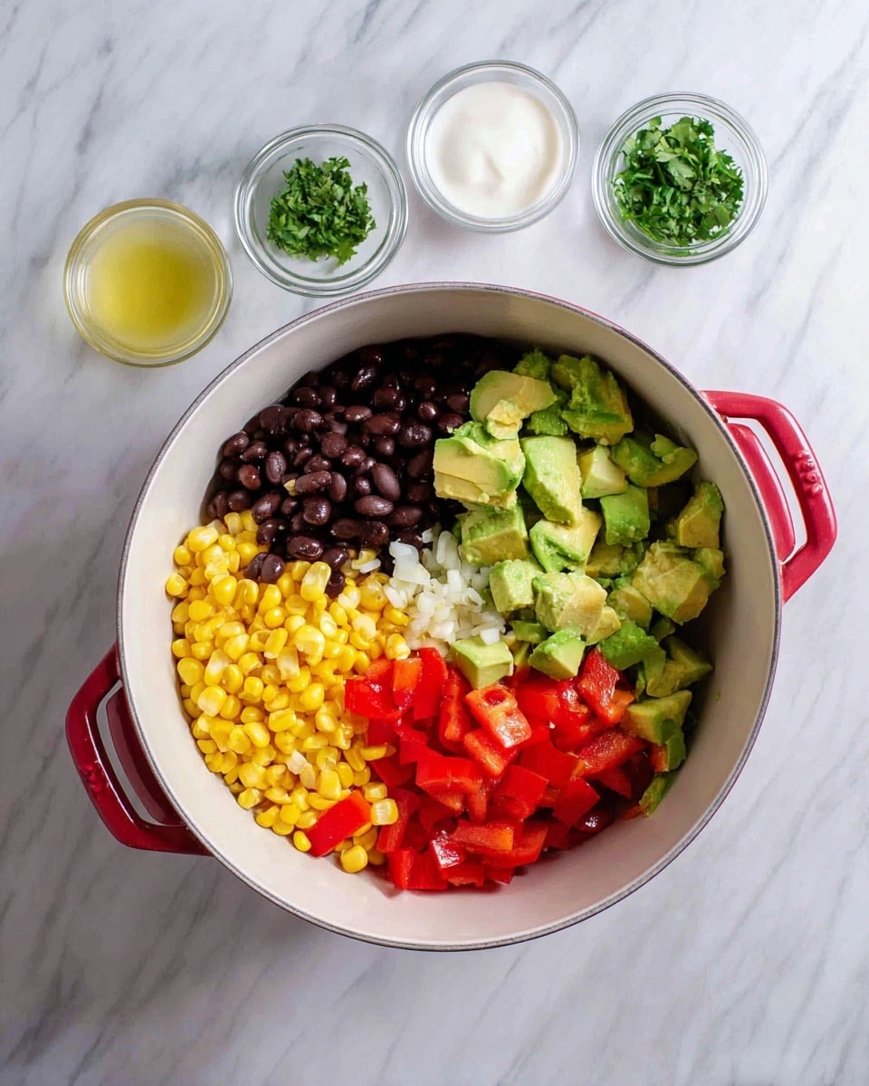 Inside a large white bowl with a red handle, there are five main layers arranged side by side: bright yellow corn kernels on the left, shiny black beans below, chopped green avocado pieces on the right, and finely diced red bell peppers above the avocado. There is also a small portion of white minced garlic near the beans. The bowl is placed on a white marbled surface. Around the bowl, three small clear glass bowls contain chopped green herbs, light yellow lime juice, and white sour cream. The photo taken with an iphone --ar 4:5 --v 7
