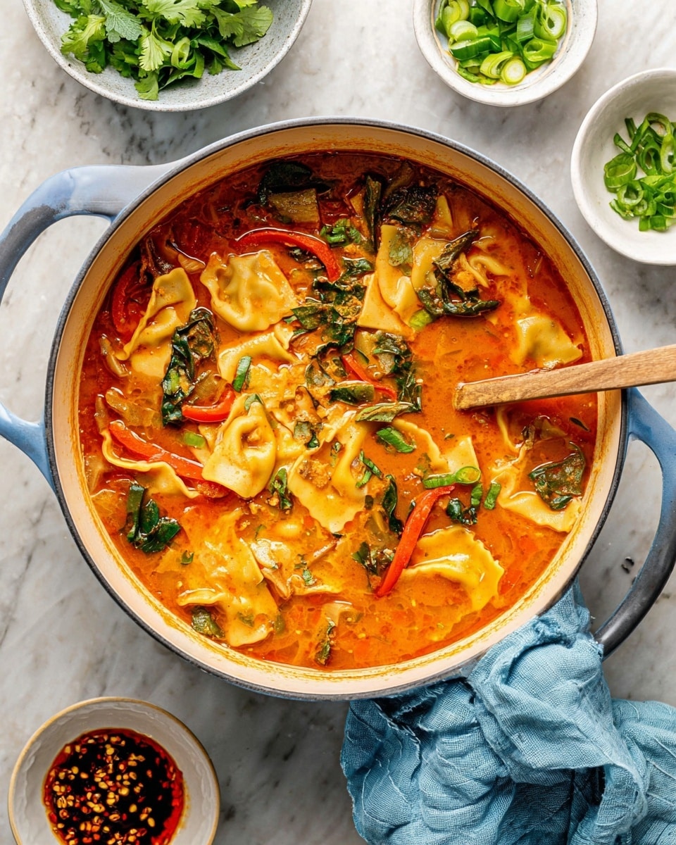 A large white pot filled with orange-red soup, with wide folded pasta pieces floating and mixed with bright green leafy vegetables and red bell pepper strips. The soup has a creamy texture with some herbs scattered on top. A wooden spoon is resting inside the pot. Around the pot, there are small white bowls filled with chopped green onions, chili oil with bits, and fresh green herbs, all on a white marbled surface. A light blue cloth is placed near the pot. Photo taken with an iphone --ar 4:5 --v 7