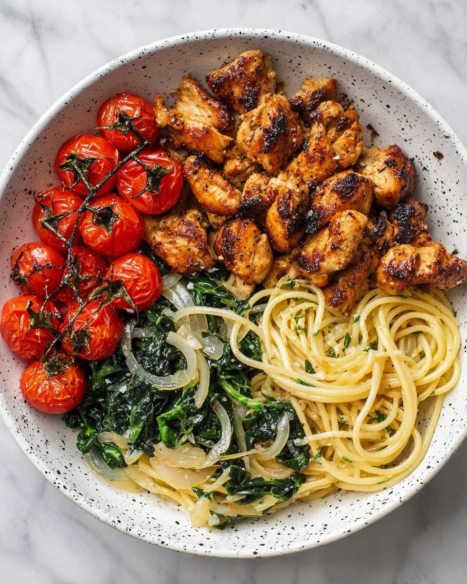 This dish is shown in a white bowl with black speckles, placed on a white marbled surface. The bowl is divided into three sections: one third has grilled cherry tomatoes that are shiny, red, and slightly blackened on the skin; the second third is filled with golden-brown seasoned chicken pieces, cooked to have a slightly crispy outside; the last third has light yellow spaghetti mixed with dark green wilted greens and thin slices of garlic, creating a mix of colors and textures. The different layers,tomatoes on top left, chicken on bottom left, and pasta with greens on the right,are all clearly visible and separate. Photo taken with an iphone --ar 4:5 --v 7