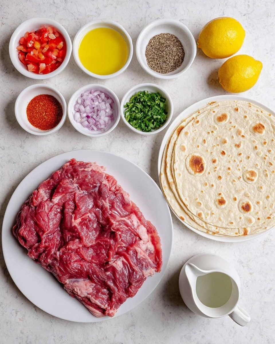 The image shows a large slab of raw red meat on a white plate on the left side. Around it are small white bowls with different ingredients: bright yellow oil, small dark brown seeds, deep red chili powder, pale salt, small dark red chili flakes, thin sliced purple onion, diced red tomatoes, and finely chopped green herbs. Two whole yellow lemons sit near the center. On the right, a stack of thin, round flatbreads with small brown spots is placed on a white plate. A small white pitcher with clear liquid is near the bottom right. All items rest on a white marbled surface. photo taken with an iphone --ar 4:5 --v 7