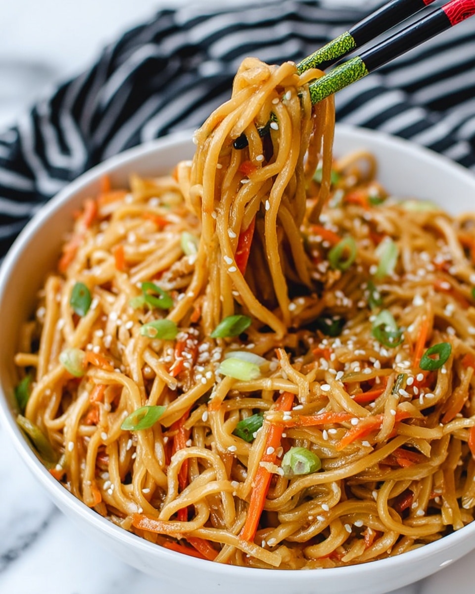 A close-up view of thick noodles mixed with shredded orange carrots and green sliced spring onions in a white bowl, the strands are coated with a light brown sauce and sprinkled with white sesame seeds. Two black chopsticks with light green and red tops are lifting a tangled bundle of the noodles from the bowl. The bowl rests on a white marbled surface partially covered by a black and white striped cloth. Photo taken with an iphone --ar 4:5 --v 7