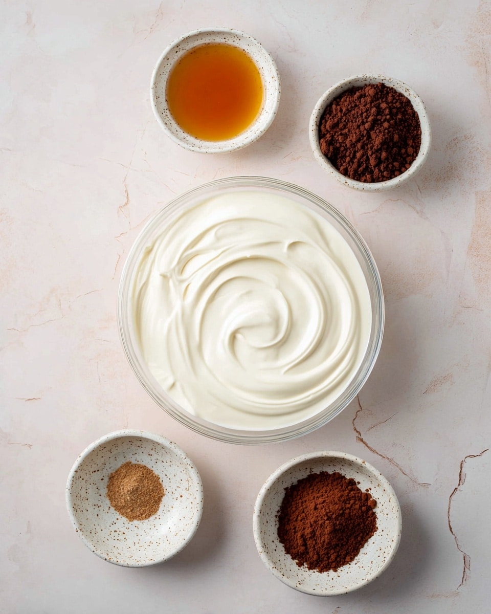 A large clear glass bowl sits in the middle filled with smooth, thick white cream with gentle swirls on its surface. Around it are four small white ceramic bowls with a speckled pattern: one at the top left filled with golden brown liquid, one top center with a darker brown liquid, one bottom right with dark brown powder, and one bottom center with light brown powder. All bowls are placed on a soft white marbled surface. photo taken with an iphone --ar 4:5 --v 7