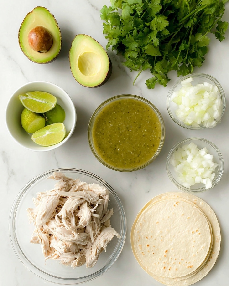 The image shows a top view of food ingredients arranged on a white marbled surface. There are two halves of an avocado with a green soft texture and a brown seed in one half. A small white bowl holds several wedge-cut green limes. A stack of white corn tortillas lies near the top right. A white bowl filled with green salsa, smooth with a few small chunks, is placed below shredded light beige cooked chicken in a clear glass bowl. Next to the chicken, a clear glass bowl contains white chopped onions. A bunch of fresh green cilantro sits at the top. photo taken with an iphone --ar 4:5 --v 7