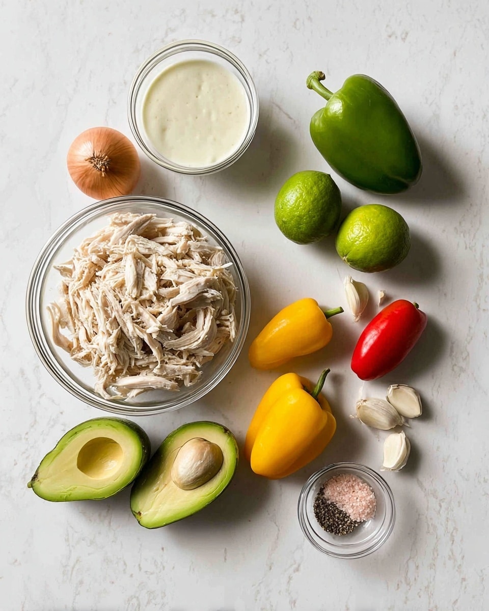 Two clear glass bowls hold fresh ingredients on a white marbled surface, one bowl filled with shredded light beige chicken, and the other with two pale green avocados cut in half showing their creamy inside. Around these bowls are whole small vegetables including a medium brown onion, a round green lime, three bright yellow mini peppers, and one red mini pepper. There are also three cloves of light beige garlic, a small clear bowl with white creamy sauce, and another small bowl containing a mix of black pepper and pink salt crystals. Photo taken with an iphone --ar 4:5 --v 7