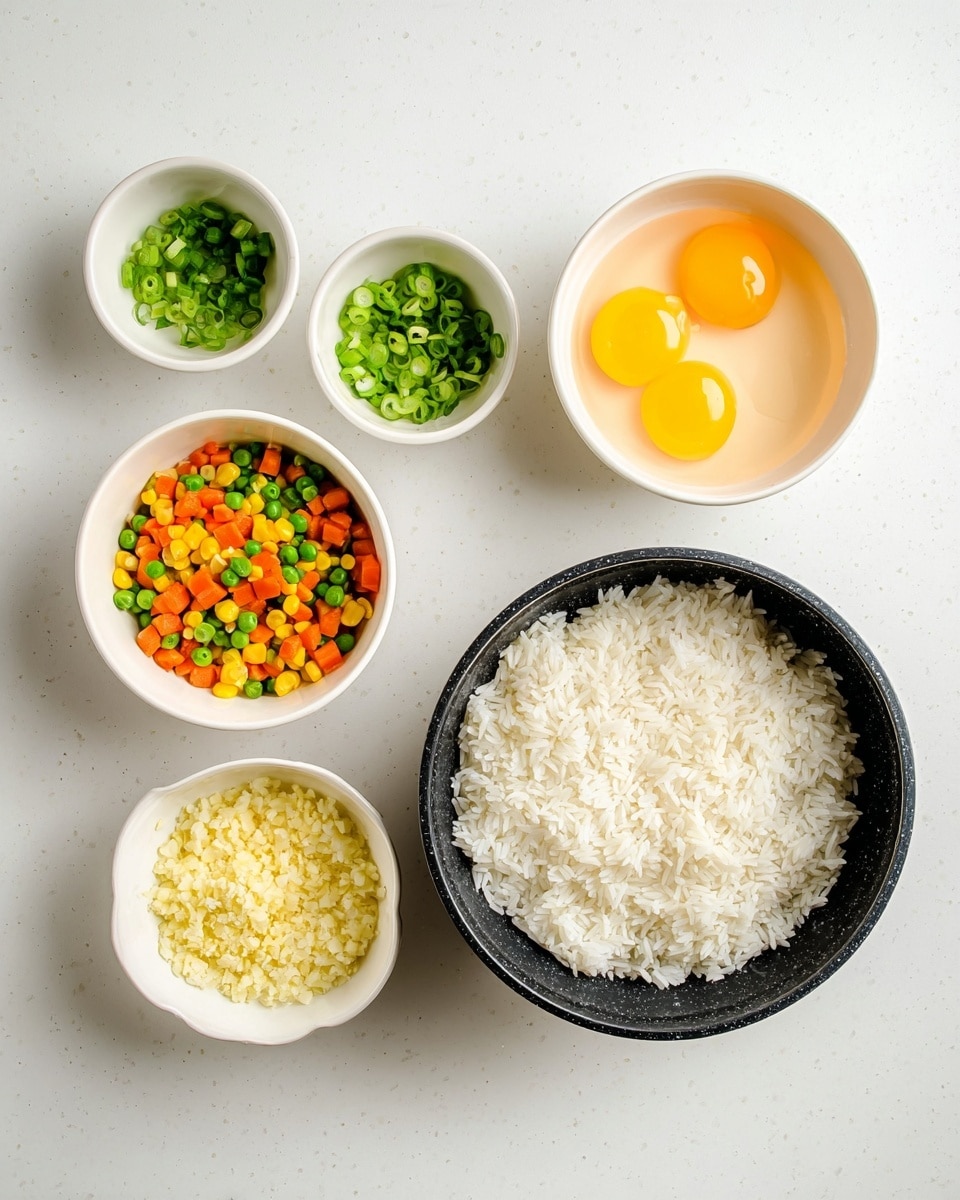 The image shows six small white bowls and one black pot arranged on a white marbled surface. The black pot on the right is filled with cooked white rice, showing a fluffy texture. To its immediate left, there are two small white bowls with green onion slices, one with a lighter green and the other with a darker green. Above these, there is a bigger white bowl filled with three raw eggs, the yolks bright yellow and whole. To the left of the eggs, a white bowl holds mixed diced vegetables, mainly orange carrots, green peas, and some corn kernels. Below that, another white bowl contains finely chopped garlic, pale yellow and slightly textured. The bowls are spread out neatly in a flat lay style, giving a clean and simple cooking prep look. Photo taken with an iphone --ar 4:5 --v 7