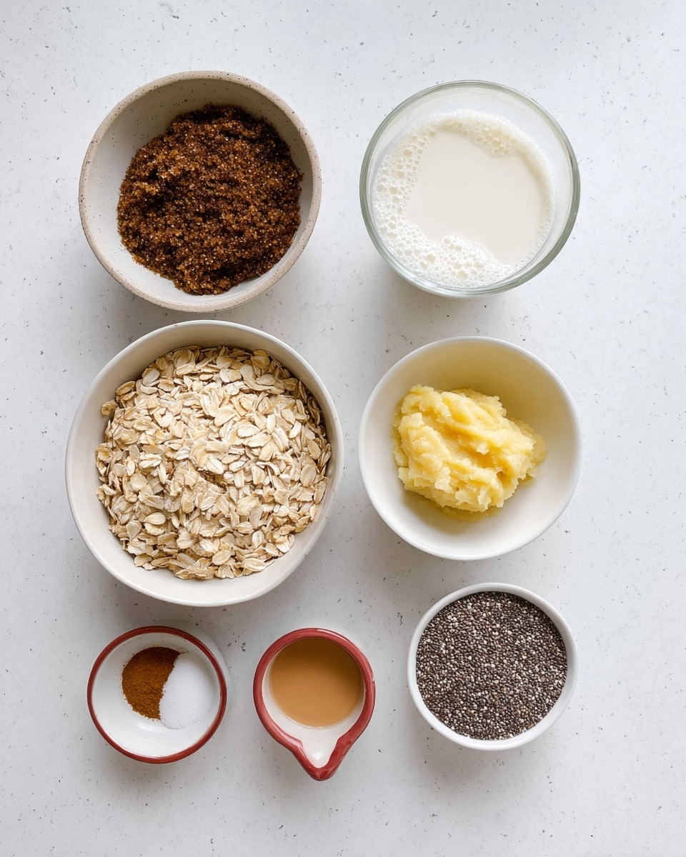 The image shows six separate white bowls and cups arranged on a white marbled surface. Starting from the top left, there is a shallow bowl filled with dark brown sugar with a grainy texture. To its right, a clear glass cup contains fresh white milk with some bubbles on top. Below the brown sugar bowl, a larger white bowl is filled with light beige rolled oats with a rough texture. Next to the milk, there is a white measuring cup holding smooth, mashed yellow banana. Below the mashed banana, a small white bowl holds a light brown liquid, likely vanilla extract. On the bottom left, a small dual-colored white and muted red dish contains a small mound of ground cinnamon and white salt. Finally, on the bottom right, there is a white bowl filled with tiny black and white chia seeds with a speckled texture. The setup is neat and brightly lit, showcasing each ingredient clearly. photo taken with an iphone --ar 4:5 --v 7