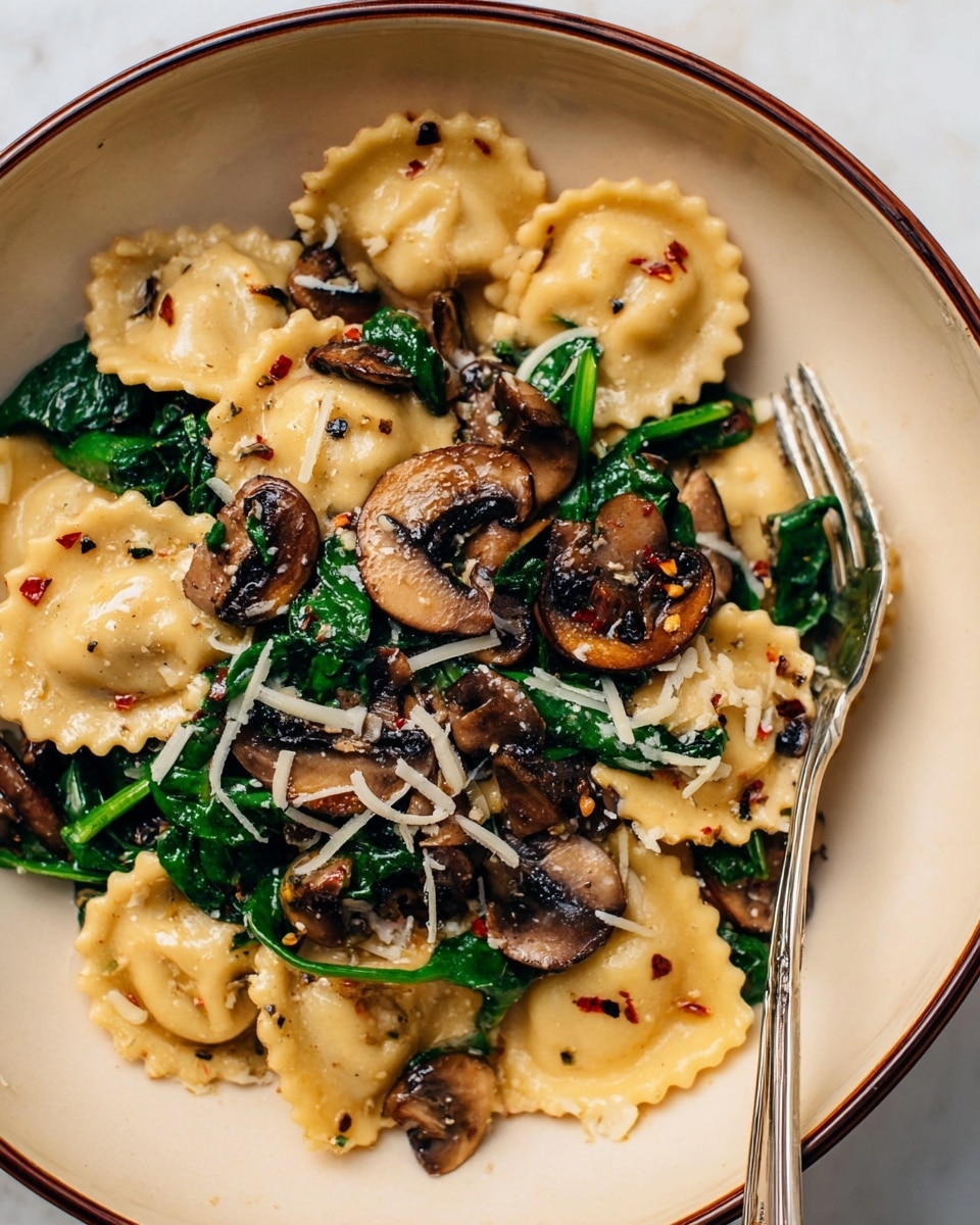 This image shows a bowl of pasta with three main layers: at the bottom, there are light beige, slightly curved ravioli with frilled edges, spread evenly. The middle layer contains dark brown sautéed mushroom slices, some whole and some chopped, mixed with fresh dark green spinach leaves, slightly wilted and glossy. On top, there are small white shredded cheese pieces sprinkled over the dish with tiny red chili flakes scattered around. The pasta, mushrooms, and spinach sit inside a white bowl with a brown rim, placed on a white marbled surface. A silver fork is resting inside the bowl at the right side. Photo taken with an iphone --ar 4:5 --v 7