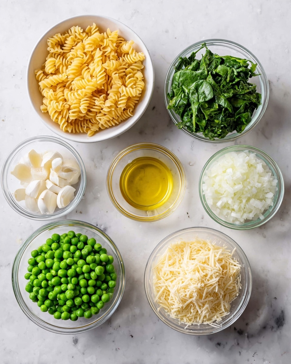 Seven small white bowls sit on a white marbled surface in an overhead view: one with small spiral dry pasta with a pale yellow color and firm texture in the top center; one with bright green peas, round and plump, at bottom left; one with chopped green leafy spinach pieces at bottom center-right; one with finely grated pale yellow cheese at bottom right; one with finely chopped white onion at top left; one with thin, sliced white garlic pieces to the left center; one with clear golden olive oil in a small glass bowl below the garlic; and one with clear pale liquid in a glass bowl at top right. photo taken with an iphone --ar 4:5 --v 7