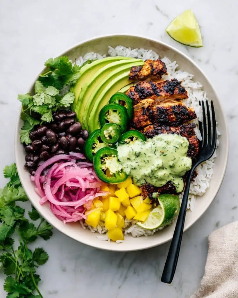 Chicken Rice Bowl with Spiced Baked Chicken, Avocado, Mango, and Cilantro Sauce Recipe