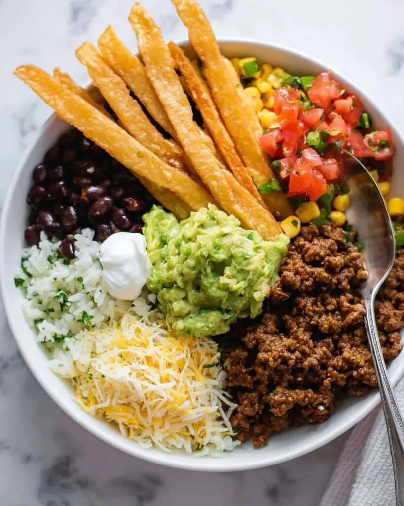 Homemade Burrito Bowls with Spiced Beef, Fresh Avocado, and Crispy Tortilla Strips Recipe