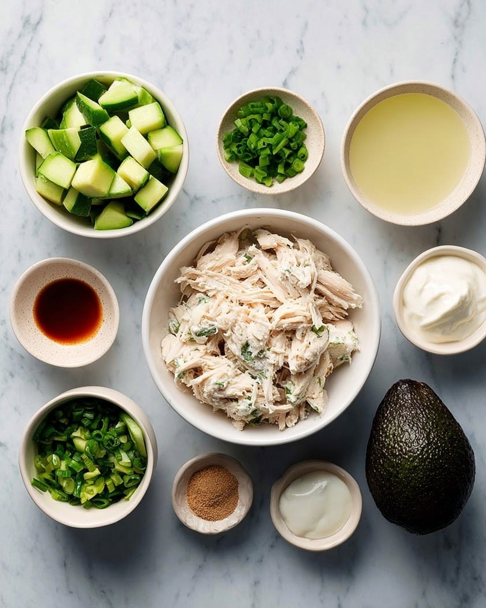 The image shows a white bowl in the center filled with light beige shredded chicken. Around it, there are small white bowls containing finely chopped green cucumbers, dark green chopped herbs, sliced green onions, creamy white sour cream, light brown dry powder, reddish-brown liquid, and pale yellow liquid. There is also one whole dark green avocado placed next to the bowls. All the items rest on a white marbled surface. photo taken with an iphone --ar 4:5 --v 7
