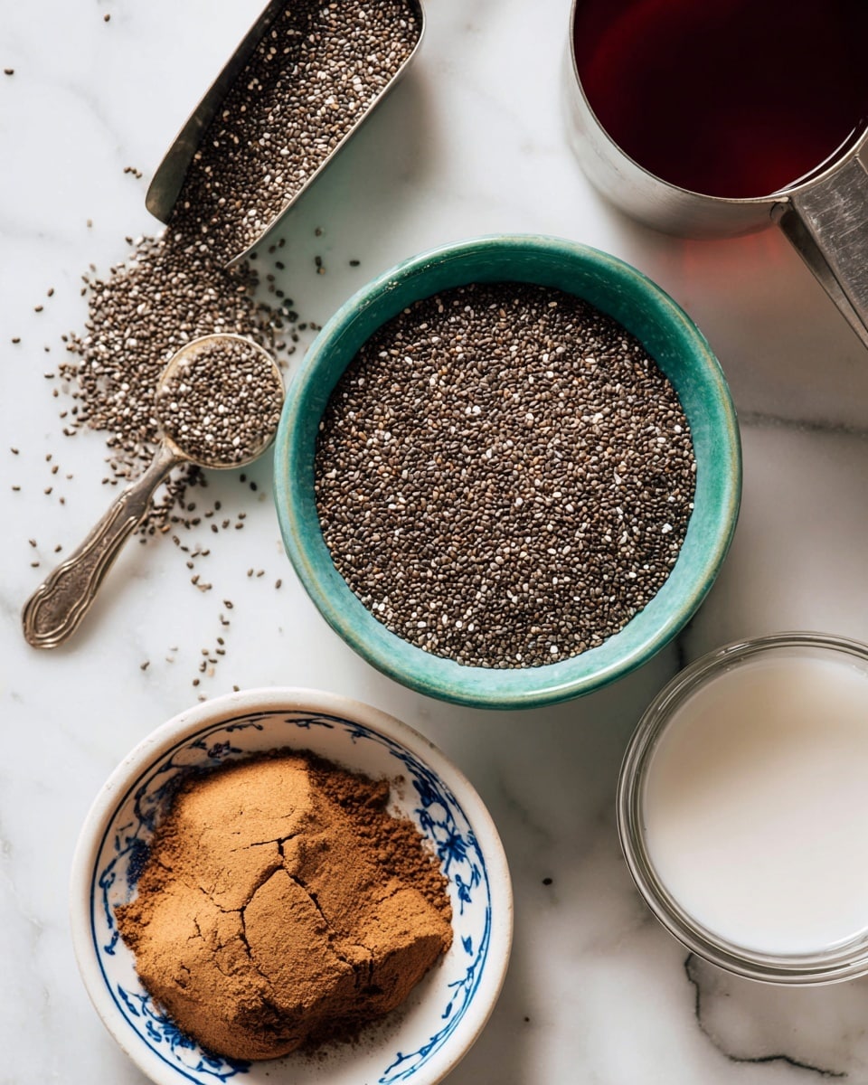 The image shows a top view of a small teal bowl filled with black and white chia seeds, with some seeds spilled around it on a white marbled surface. To the upper left of the bowl, a metal scoop holds more chia seeds. Below the bowl is a white bowl with blue patterns, filled with cracked brown powder, likely cinnamon or a spice. To the upper right, there is part of a stainless steel measuring cup filled with a dark red liquid, and at the bottom right corner, there is a clear measuring cup containing a white liquid. All items are neatly arranged on the white marbled surface. photo taken with an iphone --ar 4:5 --v 7