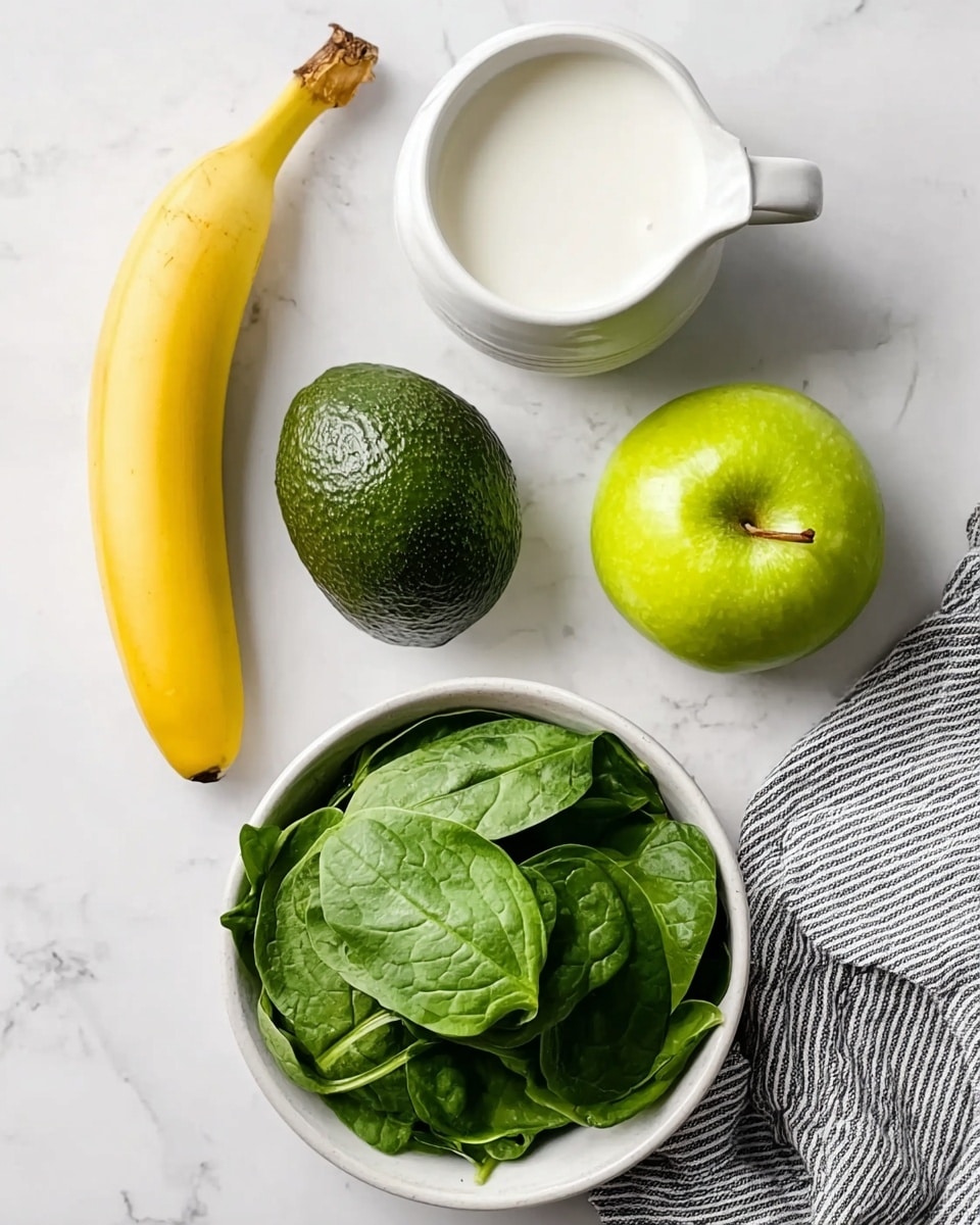 The image shows four main ingredients placed on a white marbled surface: a bright yellow banana on the top left, a white jug filled with milk in the top center, a shiny green apple on the top right, a dark green avocado on the bottom left, and a round white bowl filled with fresh green spinach leaves on the bottom right next to a folded grey and white striped cloth. The colors are fresh and natural, with a clean, light background emphasizing each item’s shape and texture. Photo taken with an iphone --ar 4:5 --v 7