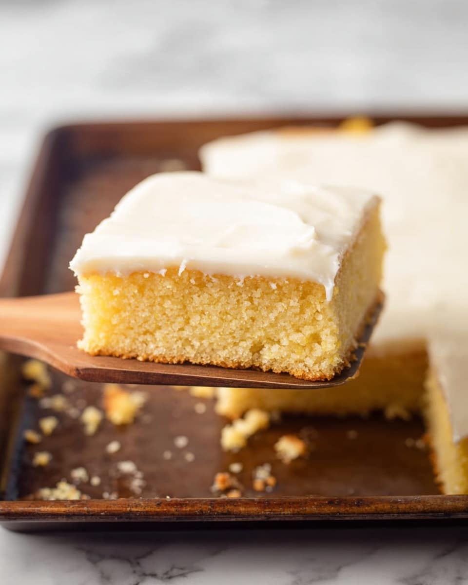 This image shows a single square piece of yellow cake with a thick, smooth white frosting layer on top. The cake has a moist, crumbly texture, and it is lifted up on a wooden spatula. Below, the rest of the cake is visible in a dark baking tray with missing pieces and crumbs scattered around. The background has a white marbled texture. photo taken with an iphone --ar 4:5 --v 7