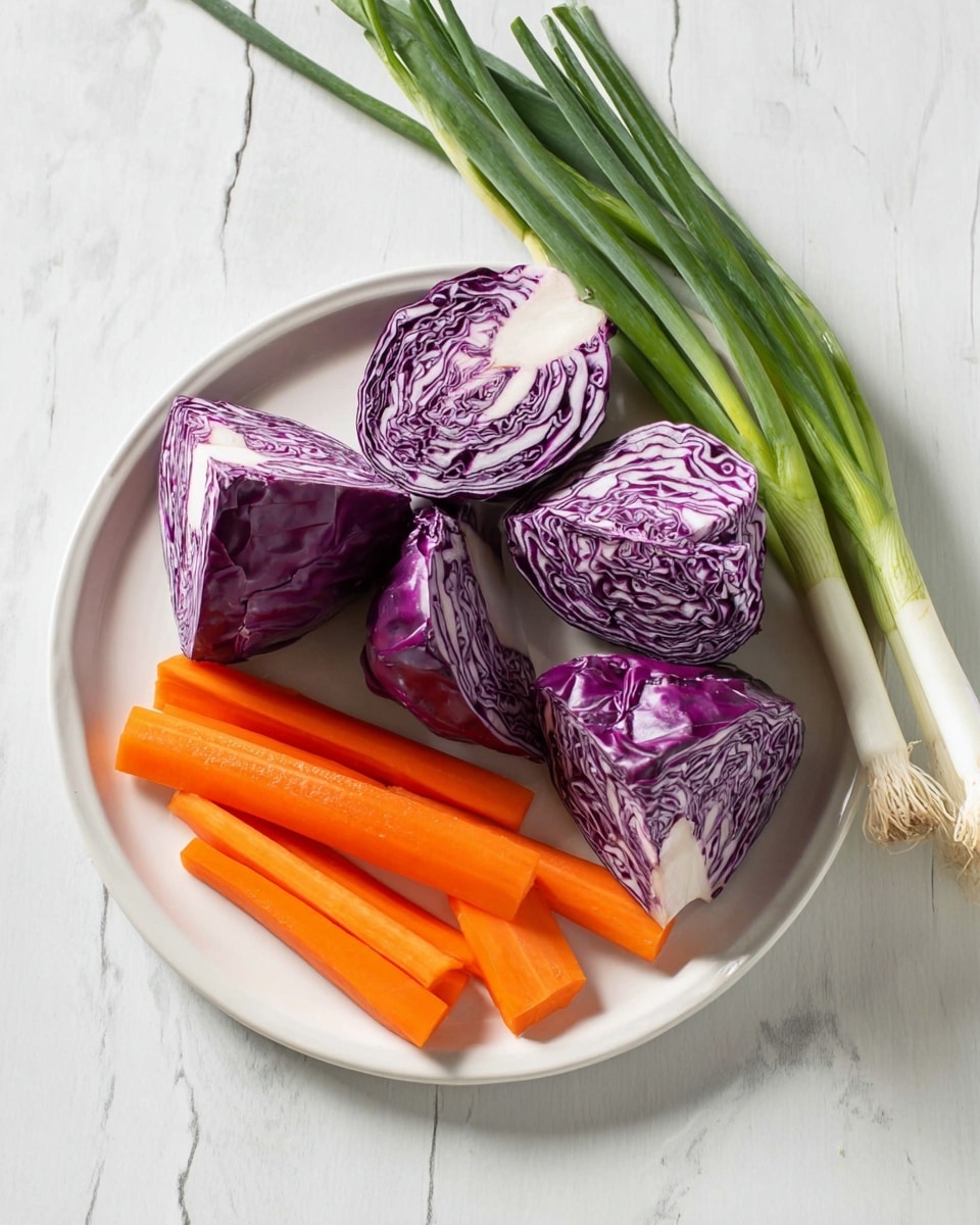 A white plate sits on a white marbled surface. On the plate are four large pieces of purple cabbage with white streaks, arranged in a loose group towards the left side of the plate. In front of the cabbage pieces are four thick, bright orange carrot sticks positioned horizontally and partly overlapping. Behind the plate, leaning slightly to the right, are three whole green onions with long green stalks and white bases. The colors are vibrant with a fresh look. Photo taken with an iphone --ar 4:5 --v 7