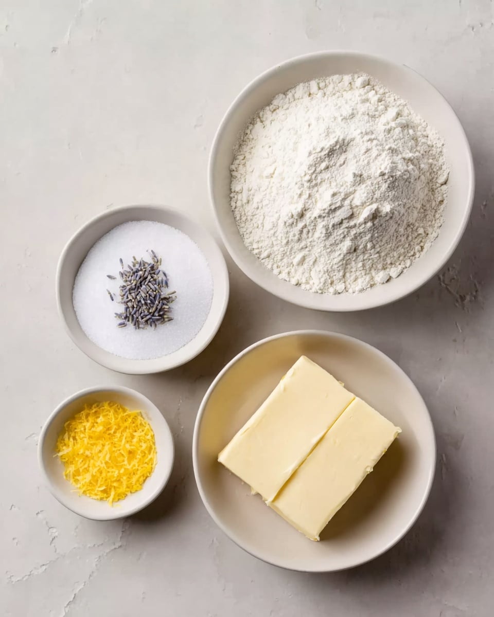 The image shows four white bowls on a white marbled surface, each holding different baking ingredients. The largest bowl at the top right is filled with a mound of white flour, coarse and powdery in texture. To the left, a slightly smaller white bowl contains fine white sugar with a few small dried lavender flowers on top, adding a touch of purple contrast. Below these, a medium white bowl holds two rectangular pieces of pale yellow butter with a smooth, solid texture. In the bottom left corner, a small white bowl contains bright yellow lemon zest, finely grated and fluffy in texture. photo taken with an iphone --ar 4:5 --v 7