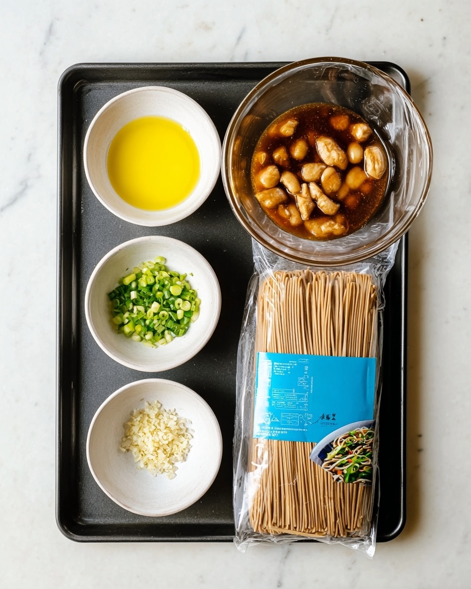 There is a flat black tray on a white marbled surface holding five items: a small white bowl with bright yellow oil, another small white bowl with chopped green onions, a small white bowl with minced garlic, a large clear glass bowl filled with small light brown pieces of food in a dark brown sauce, and a wrapped package of dry noodles with a blue label showing noodles and green vegetables. The items are neatly arranged, showing clear textures and colors against the tray. Photo taken with an iphone --ar 4:5 --v 7