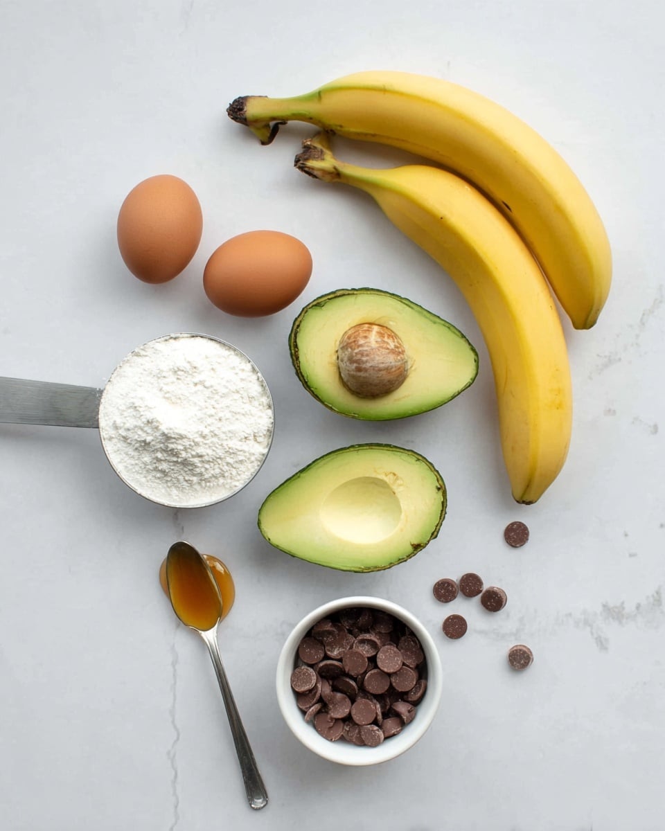 The image shows ingredients neatly arranged on a white marbled surface including two ripe bananas on the right, and a halved avocado with one half showing the seed and the other empty, placed near the center. Two brown eggs sit to the left of the avocado. On the bottom right, there is a small white bowl filled with smooth milk chocolate chips, with some scattered around. A large metal scoop filled with white flour is placed diagonally near the bowl, while a spoon with light brown syrup or honey rests on the bottom left. The colors are soft and natural, with a clean and minimalist look. photo taken with an iphone --ar 4:5 --v 7
