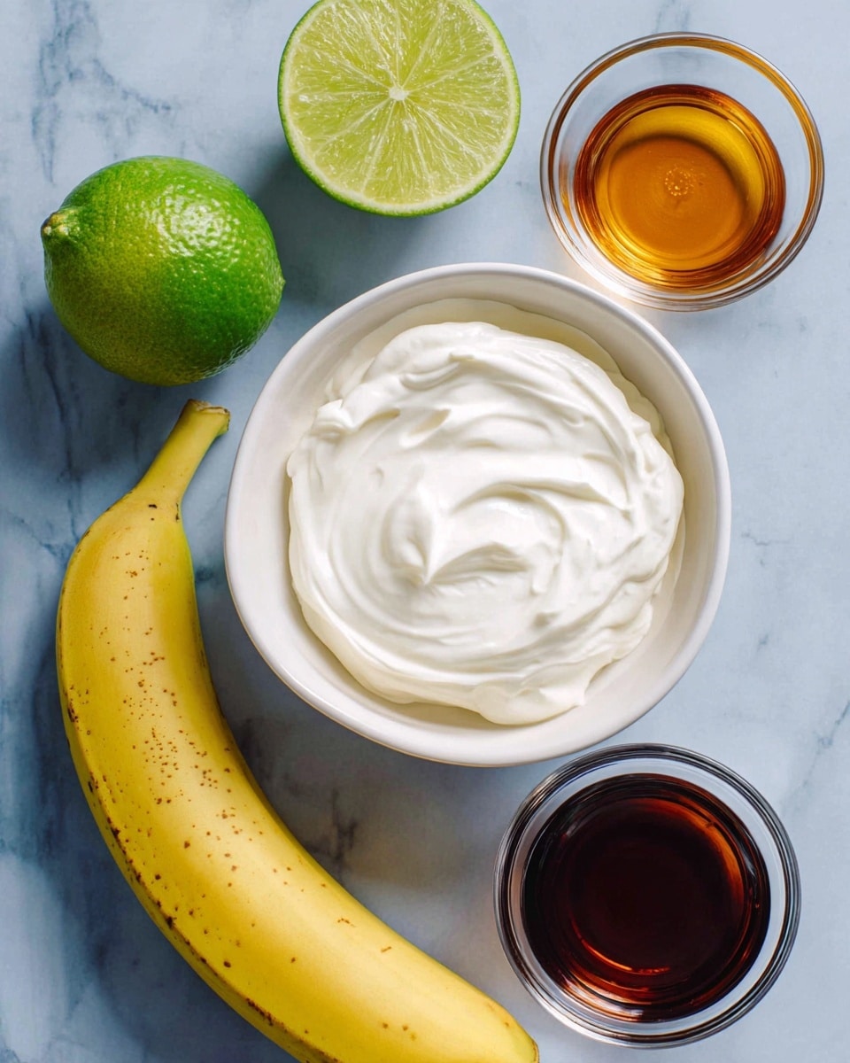 The image shows a plain white bowl filled with thick white cream placed on a white marbled surface. To the left of the bowl, there are two halves of a green lime and a whole lime with a glossy texture. Below the limes, a ripe yellow banana is placed horizontally with light brown spots. To the right of the bowl are two small clear glass bowls, one with a dark brown liquid and the other with a lighter amber liquid. The items are arranged simply with enough space around each, giving a clean and fresh look. Photo taken with an iphone --ar 4:5 --v 7